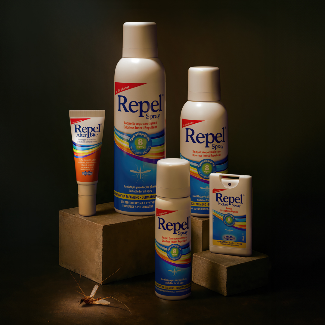 A group of five Repel insect repellent products in various sizes and forms are displayed on stone blocks, with a mosquito positioned in the bottom left corner. The background is dark and neutral.